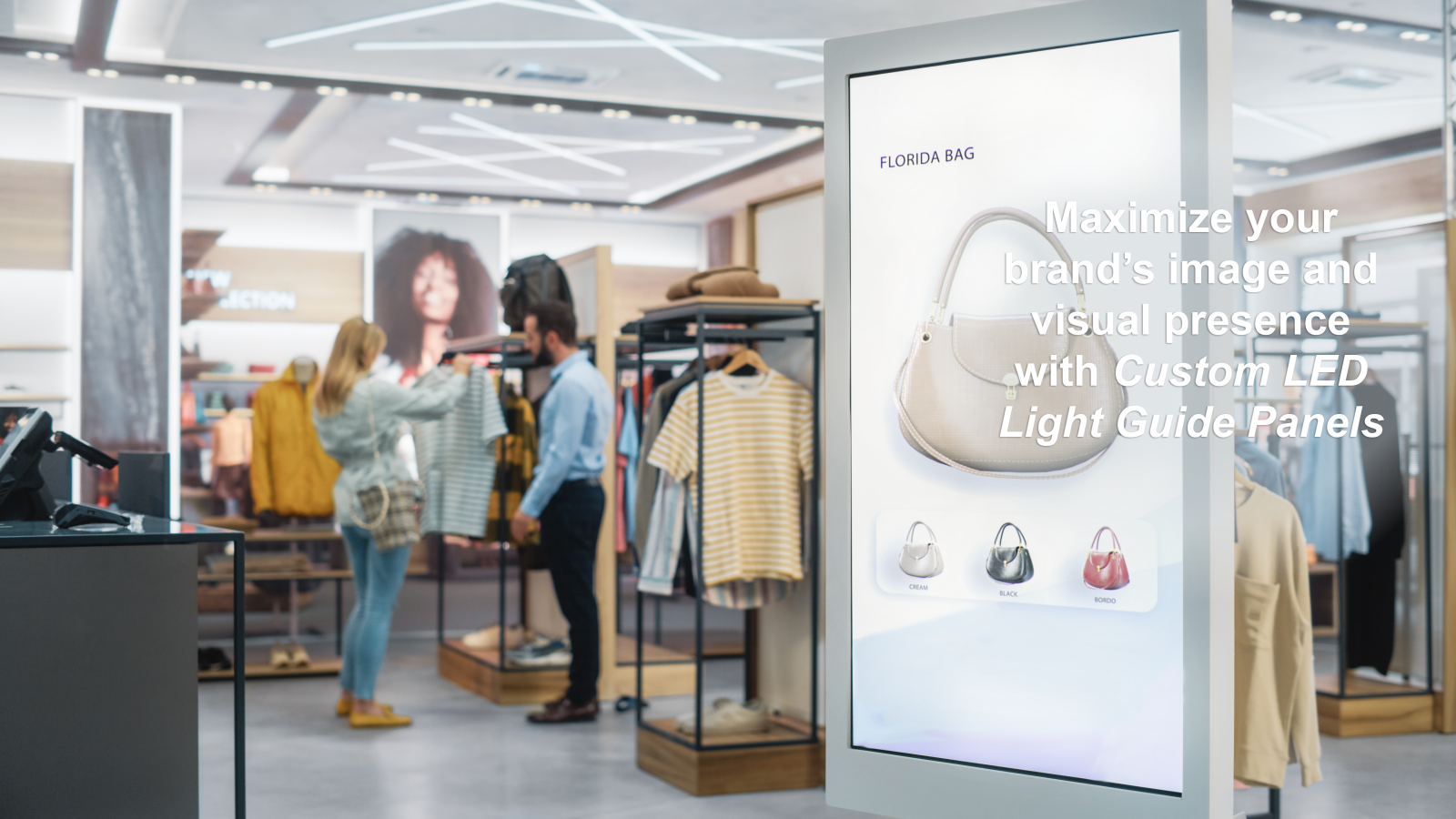 man and woman shopping in retail clothing store standing beside sign with back lighting